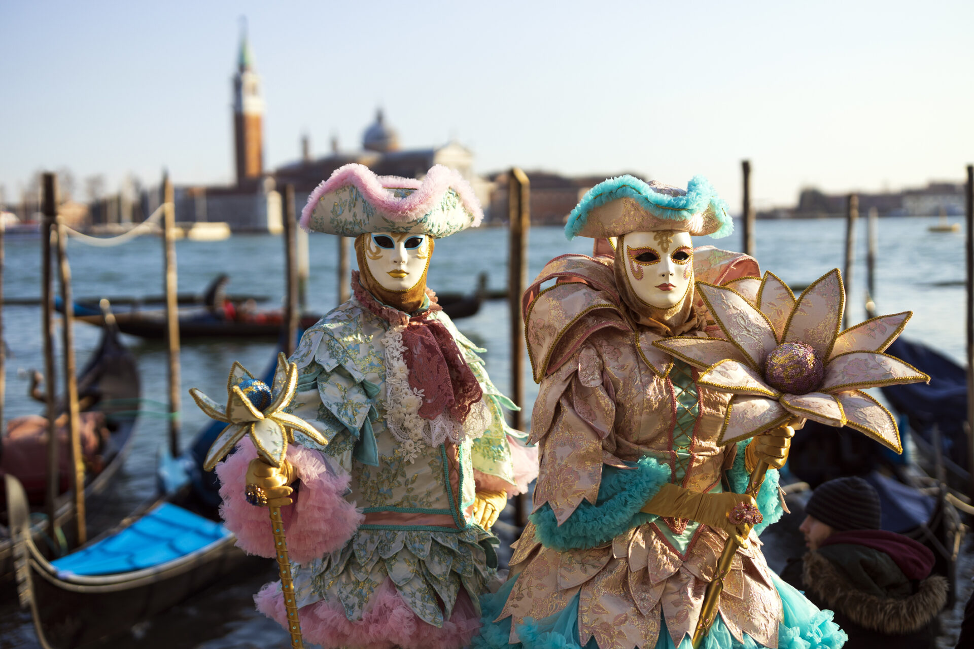 Couple wearing colorful crafted costumes at San Marco square waterfront. (Photo: istockphoto)