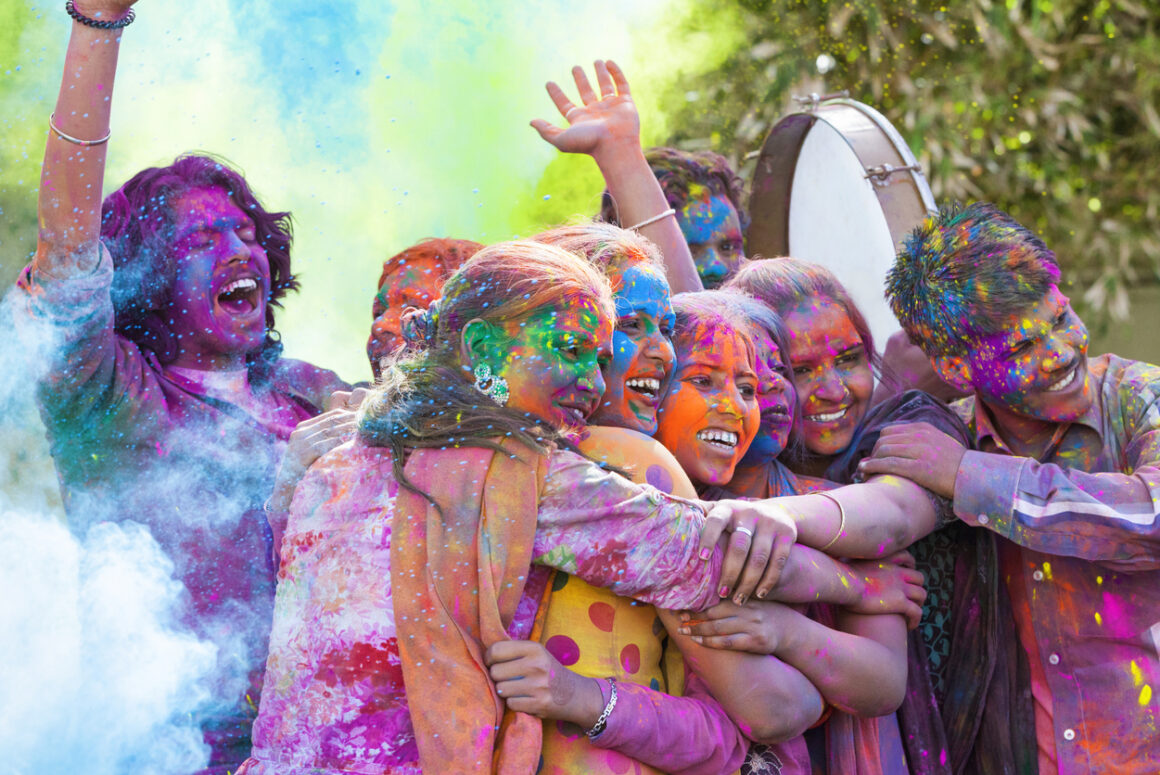 Group of young Indian friends covered in colored dye celebrating Holi festival in India. (Photo: iStockphoto)