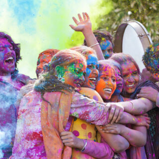 Group of young Indian friends covered in colored dye celebrating Holi festival in India. (Photo: iStockphoto)