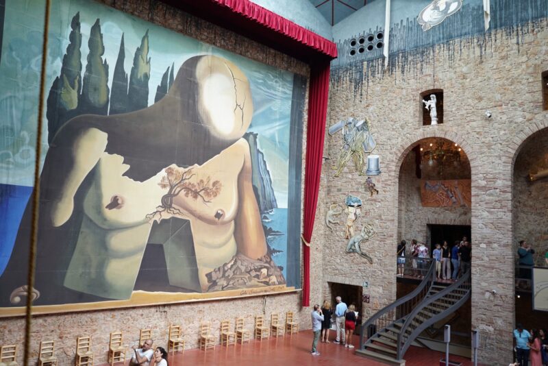 The huge surreal paintings that are hung to look like the curtains of a performance stage. (Photo Credit: Anya C.)