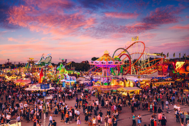 The atmosphere of the German-style fair that has 3 main zones: beer tents, food and souvenir shops, and amusement parks. (Photo Credit: iStockphoto)