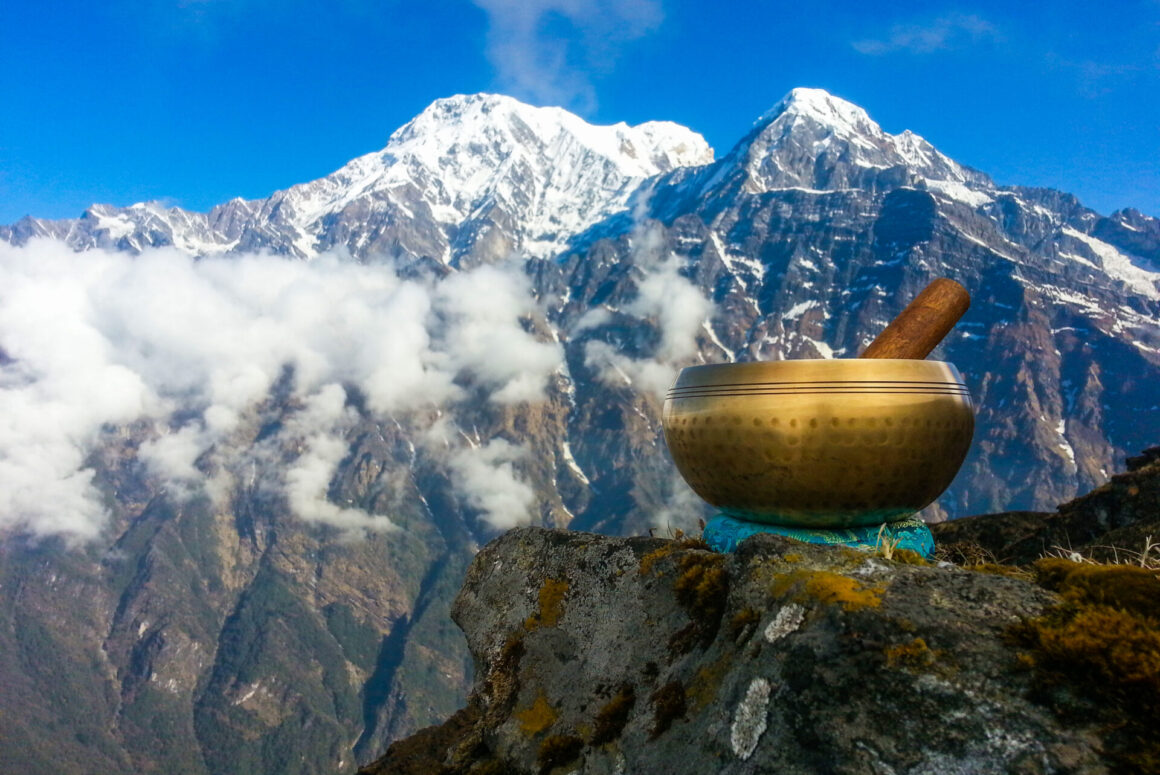 Brass singing bowls set against the backdrop of the Himalayan Mountain range. (Photo Credit: iStockphoto)