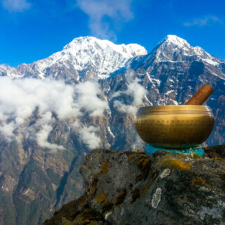 Brass singing bowls set against the backdrop of the Himalayan Mountain range. (Photo Credit: iStockphoto)