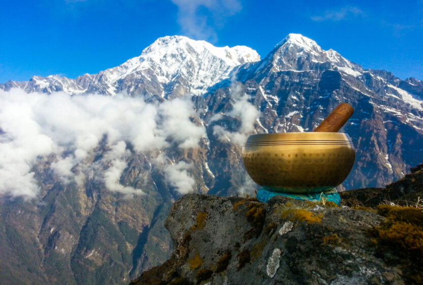 Brass singing bowls set against the backdrop of the Himalayan Mountain range. (Photo Credit: iStockphoto)