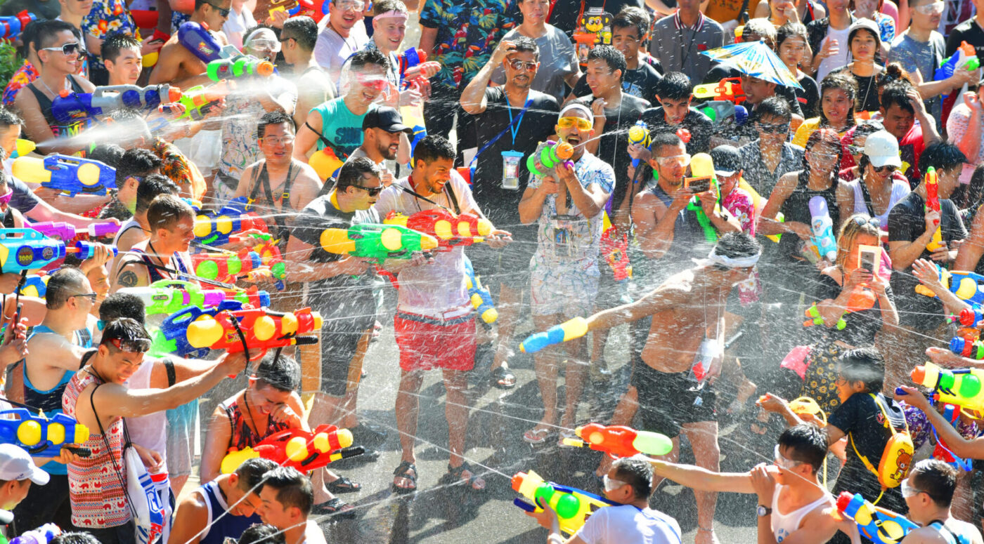 The refreshing tradition of splashing water to beat the heat during Songkran festivities. (Photo Credit: iStockphoto)