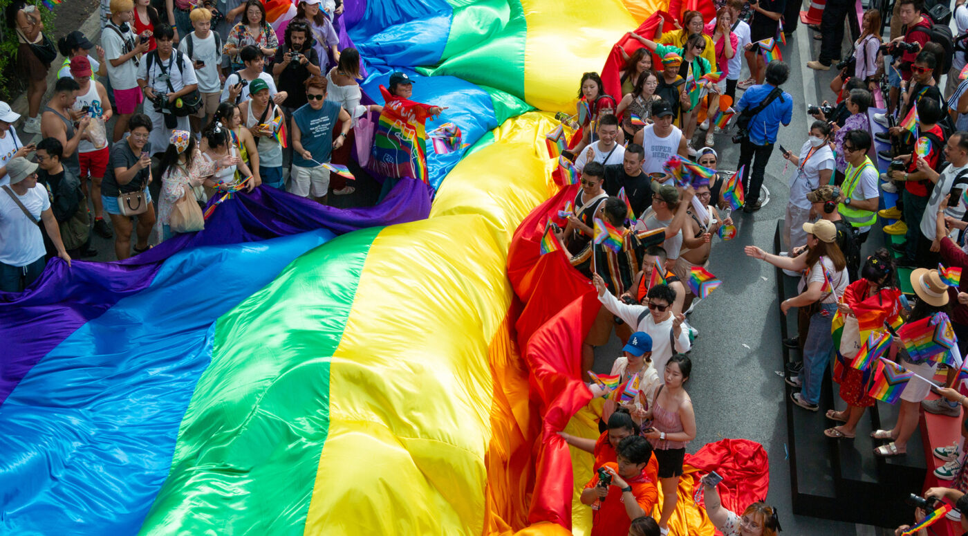 A giant PRIDE flag in the parade