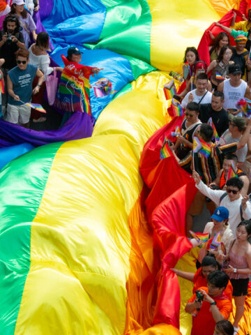 A giant PRIDE flag in the parade