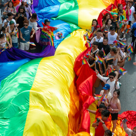 A giant PRIDE flag in the parade