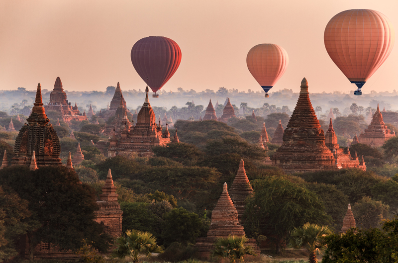 Hot air Balloons drifting over Bagan in the misty morning.