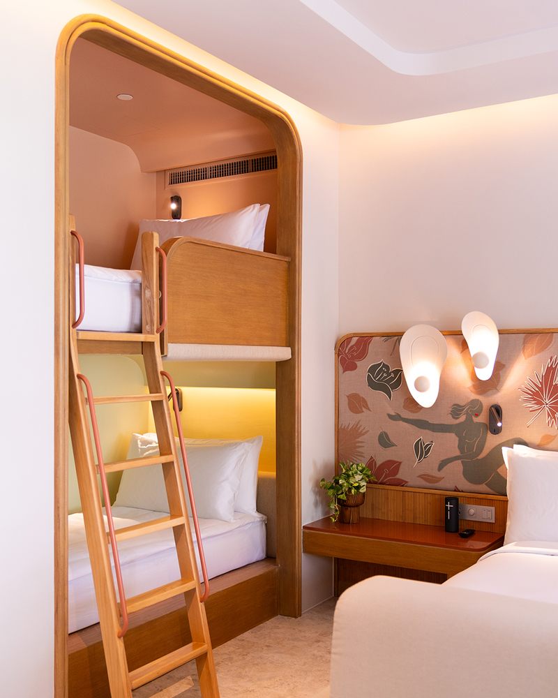A spacious room equipped with a bunk bed for kid.