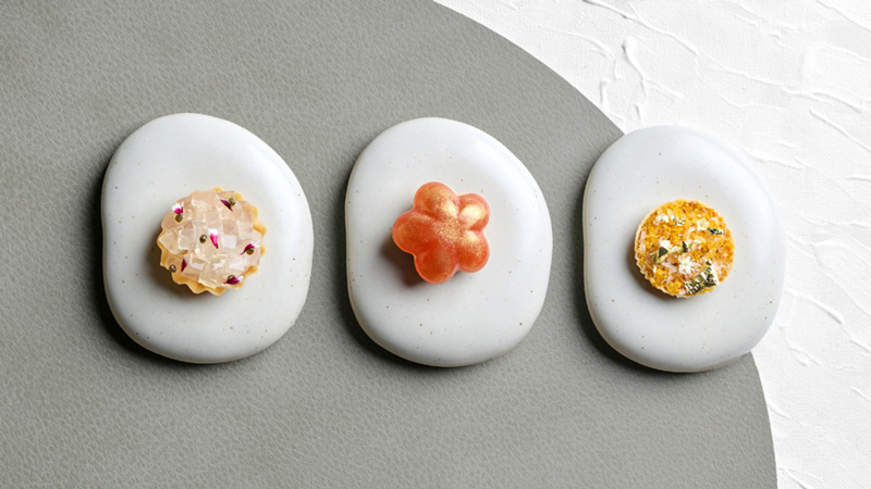 The chef curates the delicate bites with precision.