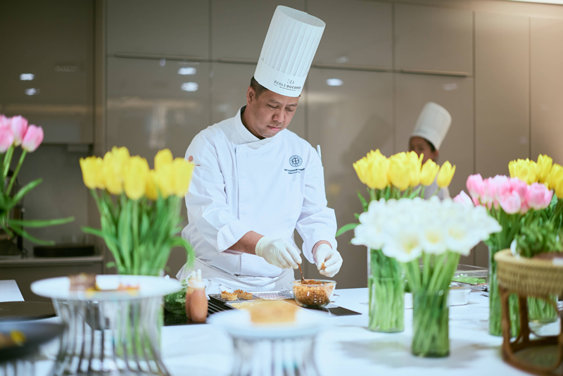 Chef is preparing the meal in the open space.