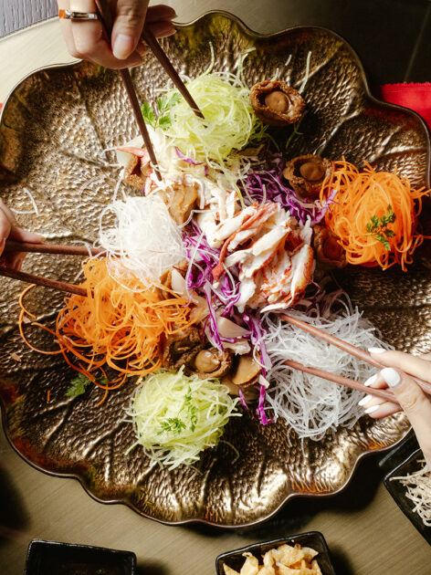 Yu Shen is a symbolic, colorful salad eaten during Chinese New Year.