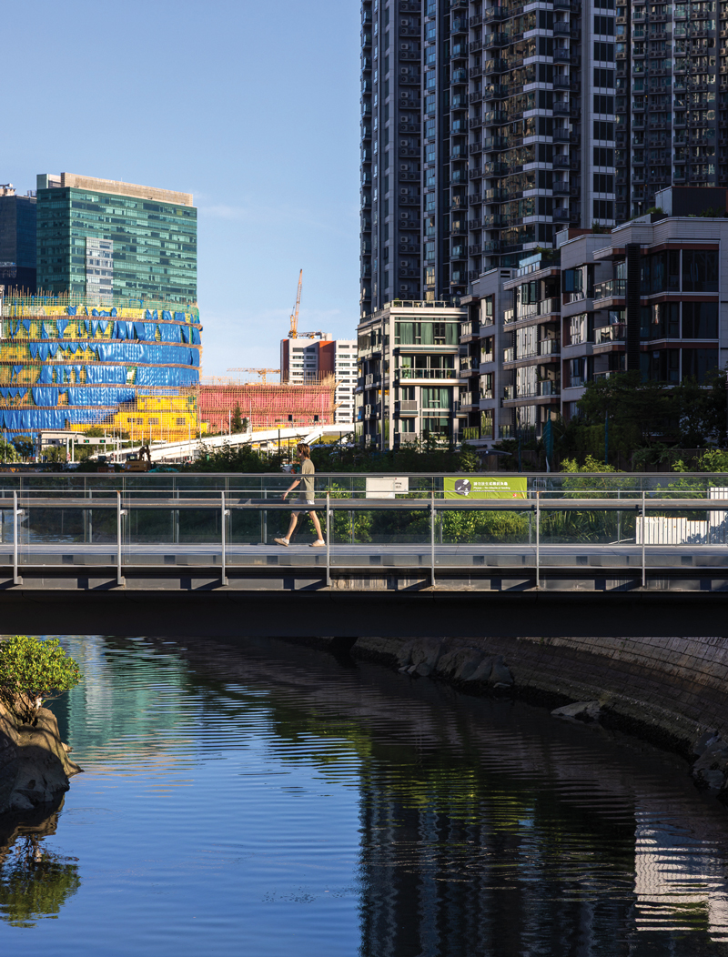 Modern urban development frames the waterfront promenade, transforming the former aviation hub into a vibrant leisure district.