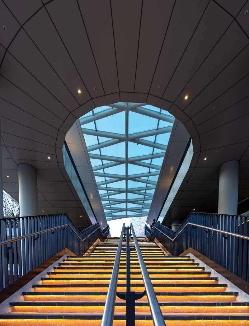 Modern architectural design plays masterfully with space and light, creating a dramatic visual journey that draws visitors upward and inward.