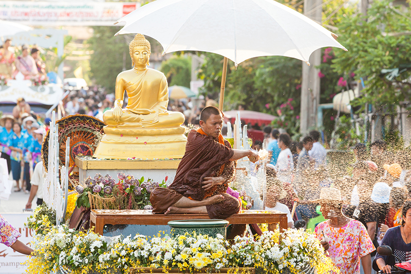 Buddhist monk Sprinkling the holy water during the traditional Thai New Year festival in Phra Pradaeng.