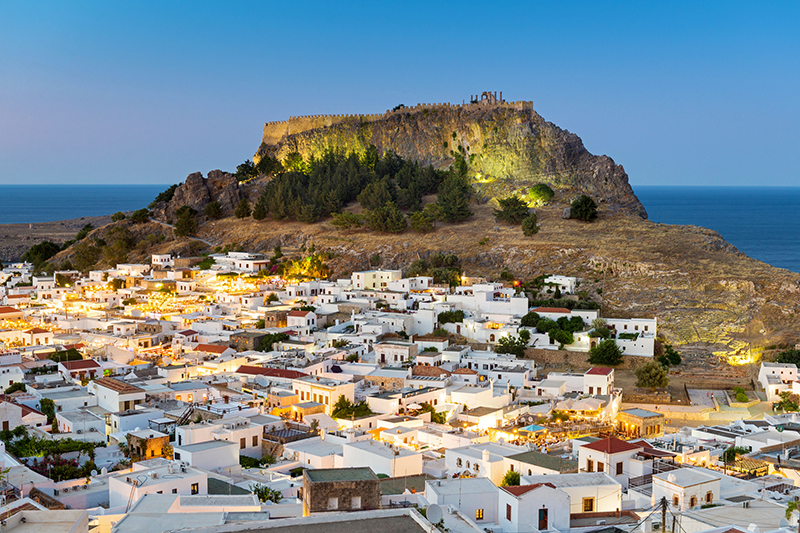 White rooftops of Lindos with the Acropolis of Lindos.
