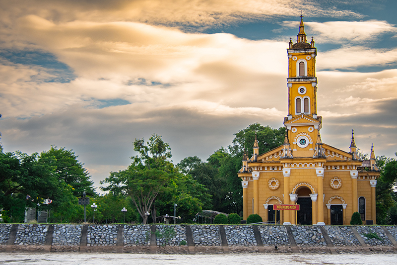 A stunning, historic Roman Catholic gem on the Chao Phraya River, featuring beautiful yellow Romanesque architecture.