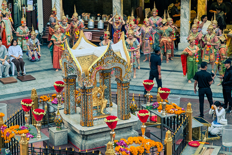 Amidst the swirling incense of the Erawan Shrine, the dancers continue their rhythmic rituals.