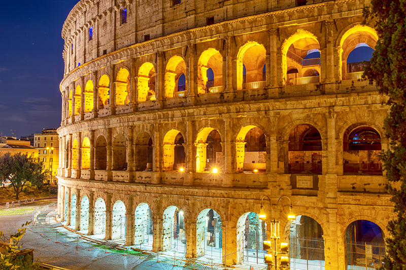 The Colosseum illuminated at night.