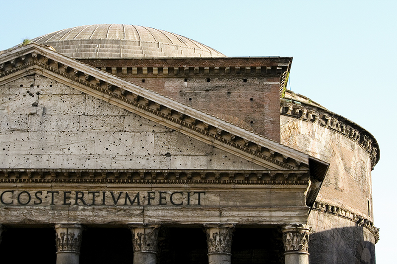 A facade that hides a sphere. The rectangular porch gives no hint of the perfect celestial rotunda waiting inside.