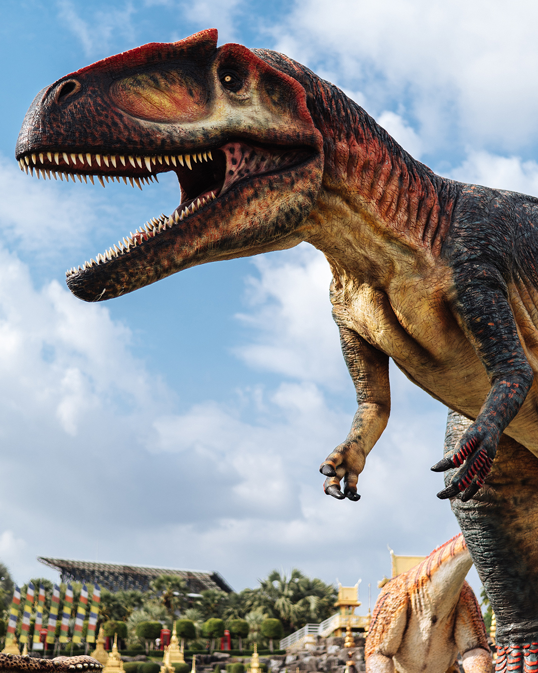 T-Rex in front of gold chedis