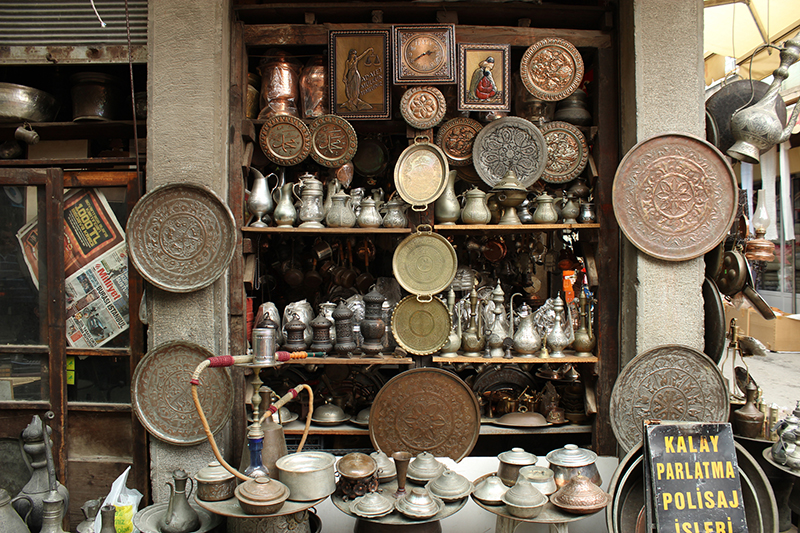 Izmir, Turkey - March 14, 2012: Copper shop with lots of new and old copper objects in Kemeraltı, Izmir. They also make tin coating, polishing to old coppers as they have a sign about it.