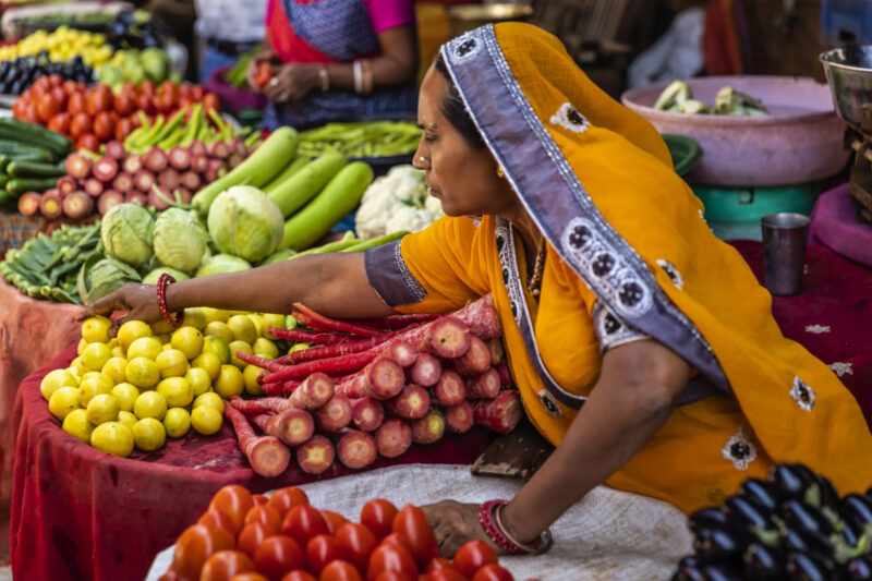 Indian street sellers selling vegetables on the street.