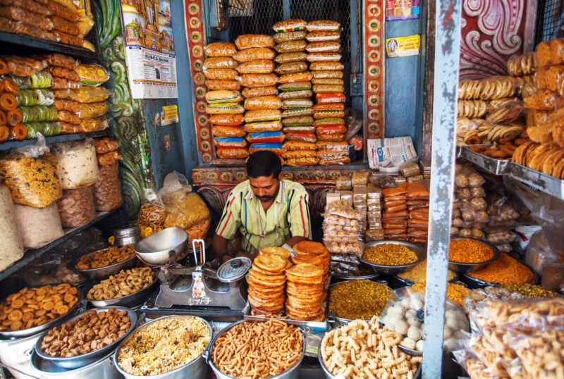 Trader inside a sweets store selling tasty biscuits and snacks.